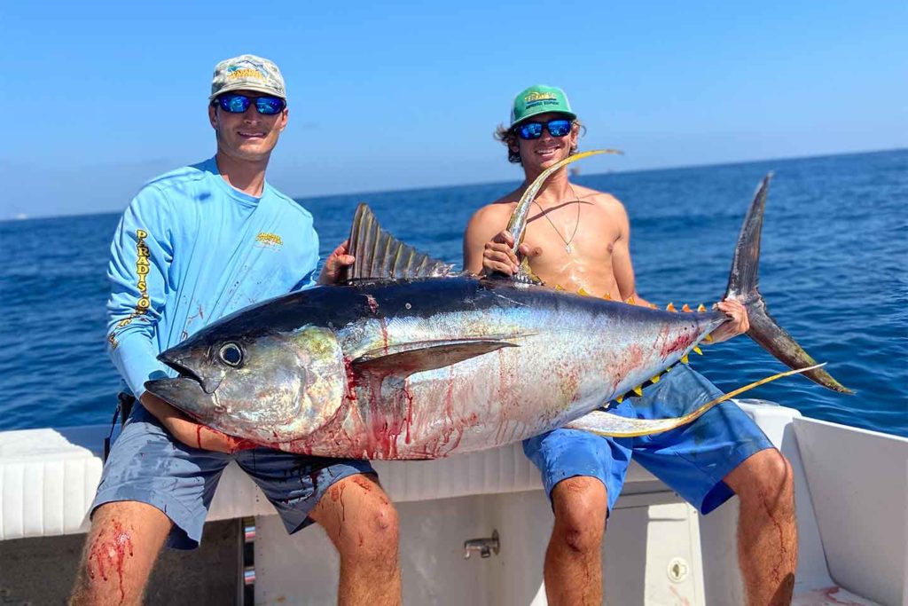 Venice, Louisiana fishing guide Christian Patin holding a huge yellowfin tuna with Paradise Outfitters