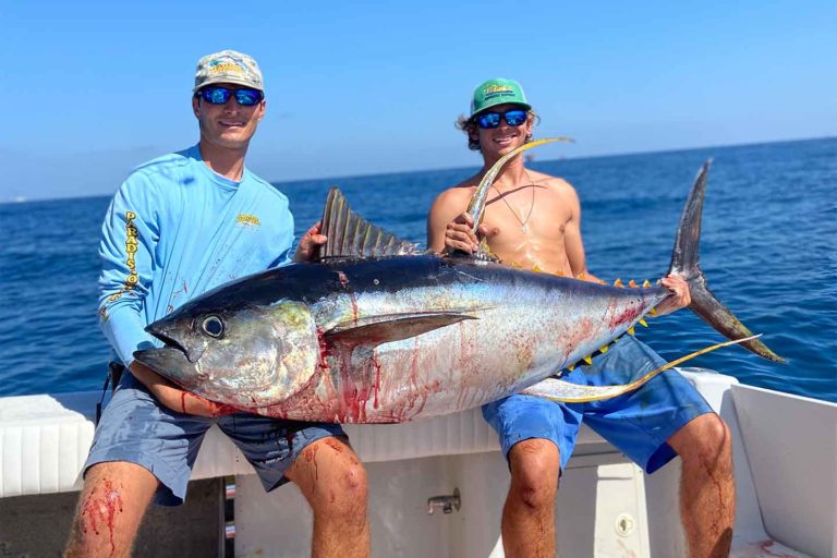 Venice, Louisiana fishing guide Christian Patin holding a huge yellowfin tuna with Paradise Outfitters