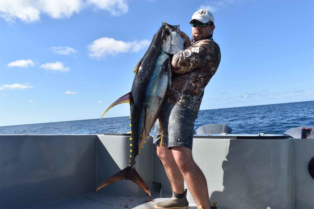 male on a tuna charter in the Gulf of Mexico out of Venice Louisiana holding a yellowfin tuna